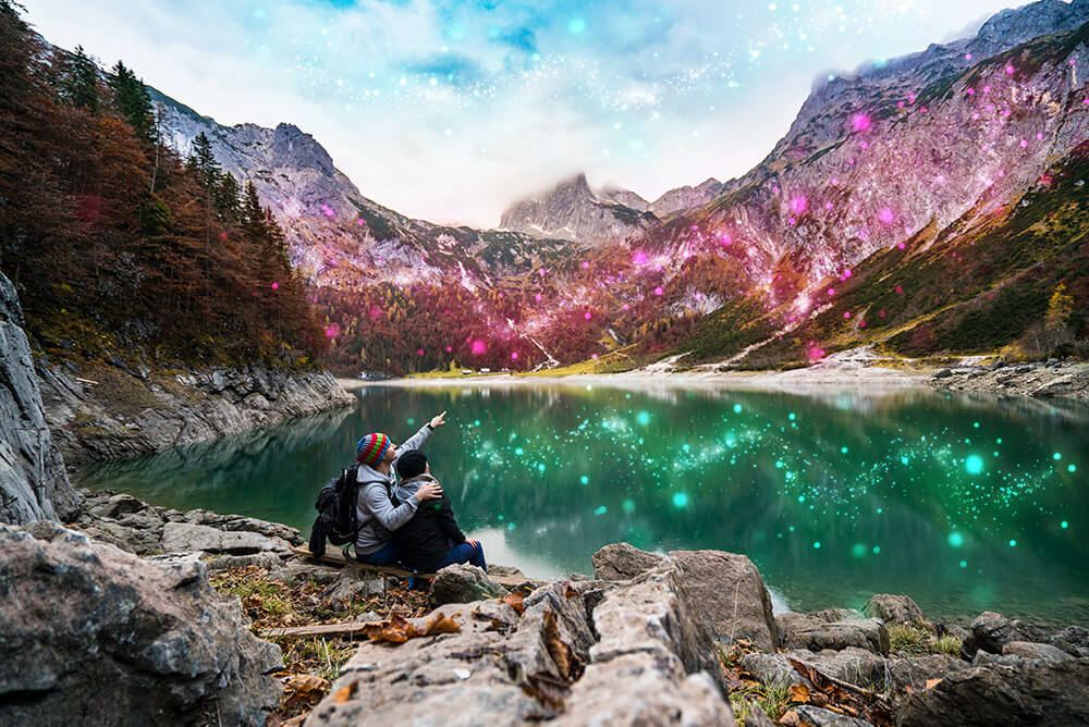 Photoshop manipulation: Couple pointing at mountain with sparkle effects